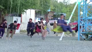 Taliban fighters enjoy an amusement park