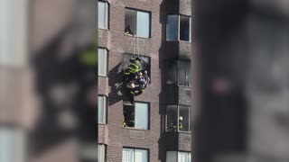 Firefighters rescue person trapped in burning New York apartment building