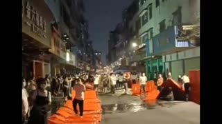 People in the Chinese City of Guangzhou Tear Down COVID Barricades