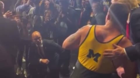 NCAA wrestlers, including champ Patrick Glory, walk over to shake President Trump’s hand