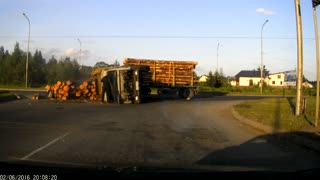 Logging Truck Loses Control and Tips Over