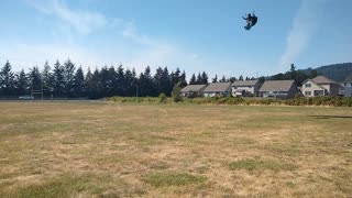 Paraglider Landing in Open field during Softball Tournament