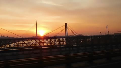 Driving Vehicle Over a Bridge During Amazing Sunset