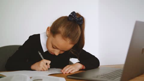 Girl Writing on Her Notebook