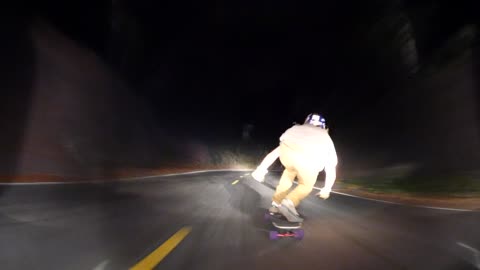 Skilled Nighttime Downhill Skateboarding