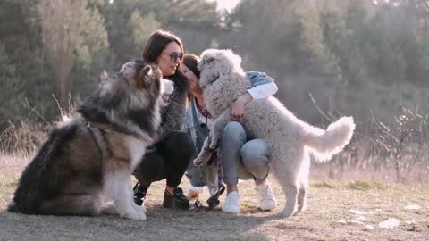 Women Holding Their Dogs