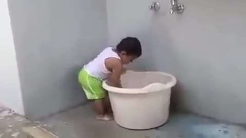 CUTE LITTLE BABY BOY HELPING MOM IN LAUNDRY