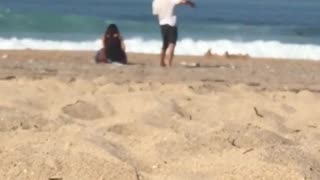 Guy gently dances by himself at the beach