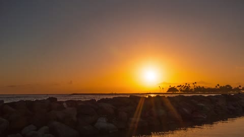 Beautiful Sun Set Time Lapse Footage of Rock Boulders Used As Seawall at a Sea Bay