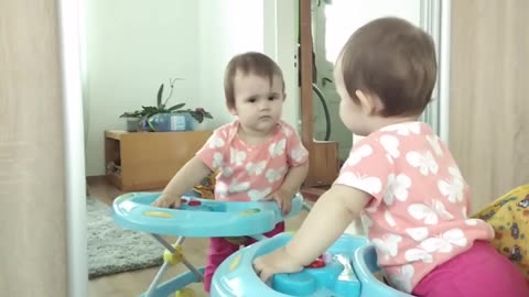Funny_Reaction_of_a_Cute_Baby_to_her_Reflection_in_the_Mirror