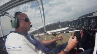 Skilled Pilot Touches Ground Mid-Flight With Stunt Plane Wing