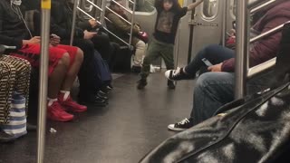 Little boy dances on subway train, hip hop song