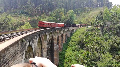 Train crosses the nine arch bridge