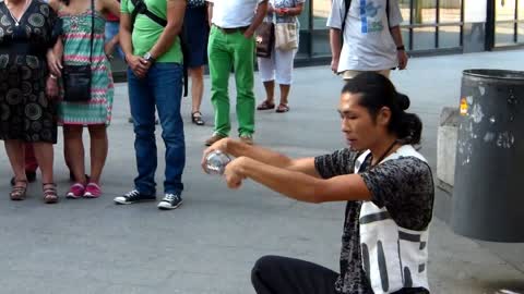 A street artist playing with a sphere of glass !