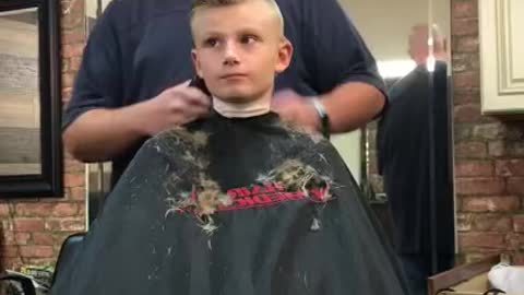 Barber pranks kid by pretending he’s cut his ear off