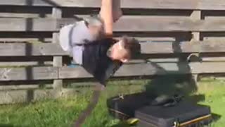 Kid in black shirt does side flip off of black platform falls on grass