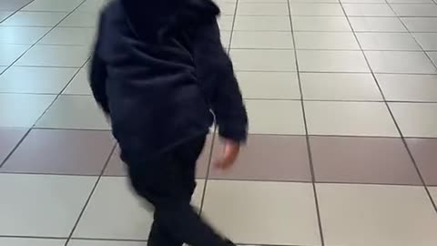 little boy dancing in the shoping