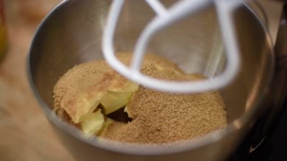 Slow Motion Brown Sugar Being Poured over Butter