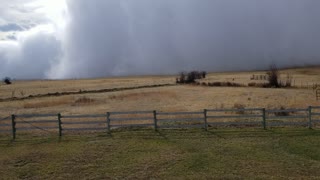 Squall Cloud Sweeps Across Field