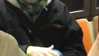 Old man plays with anti gravity ball on subway train