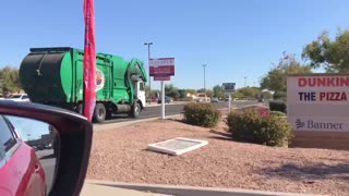 AZ Bros Autocar WX64 McNeilus front loader driving bye.