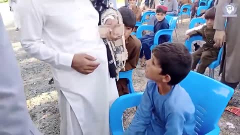 Taliban leader Qari Saeed Khosty giving Cash among Orphans