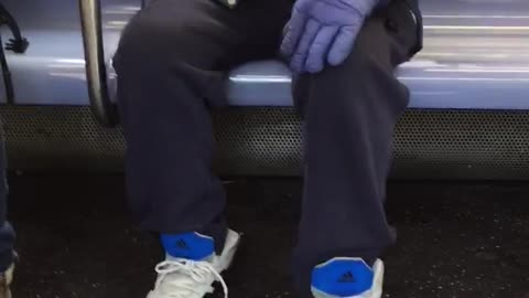 Man repeatedly strokes handrail on subway train