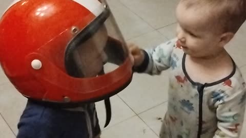 Baby Twins Playing With Helmet