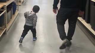 Little Boy Practices Walking Like Dad