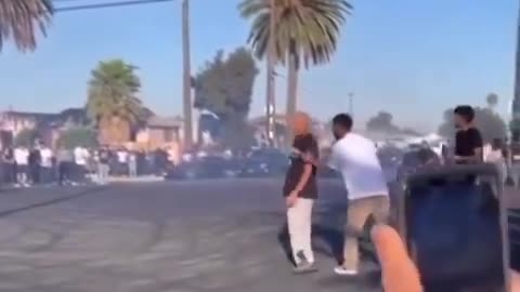 Man gets pocket checked and slapped after being hit by a car doing donuts