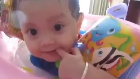 Cute baby playing in the indoor pool