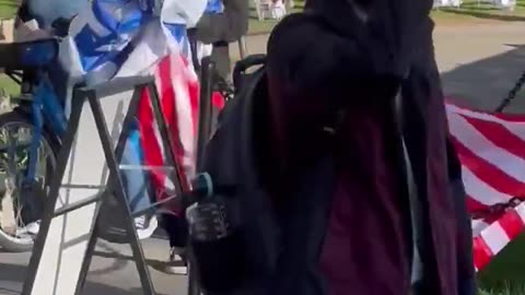 Woman Tearing Down US & Israel Flags