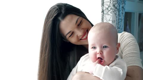 Happy mother hugging her baby