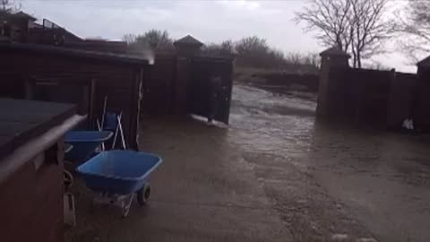 Gust of Wind Blows a Person Over While Trying to Pull a Gate