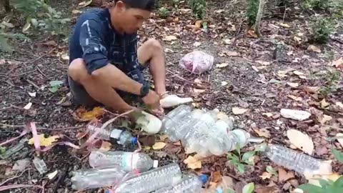 camping in heavy rain while building a floating house from used bottles