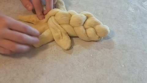 Teaching my daughter how to braid challah bread
