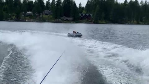 Guy Flips Into Water While Tubing as His Friend Films