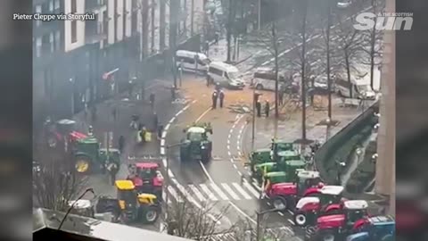 Tractors destroy police barricades with streets covered in manure by protesting farmers