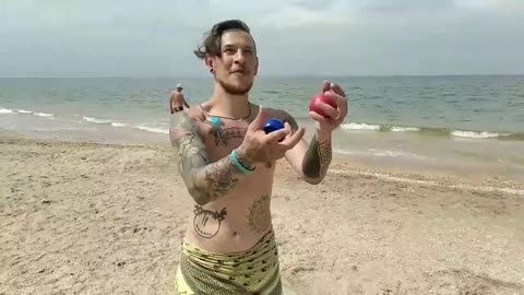 Ball juggling on the beach