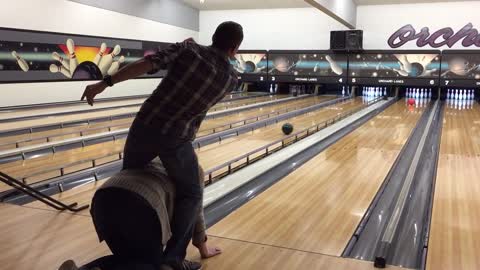 Straddle bowling trick shot. Strike!