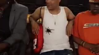 Man white shirt with tarantula on stomach