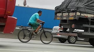 Bicycle Catches a Ride Behind Truck