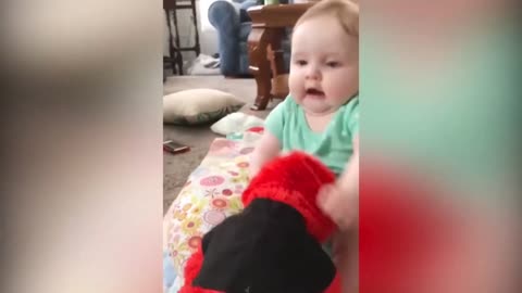 Baby wrestles with a toy doll