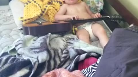 Toddler playing guitar