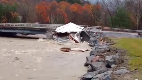 House being swept away in the river gets torn to shreads by a bridge