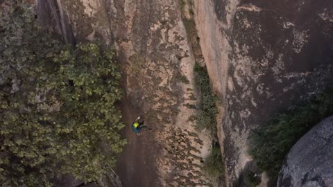 Mountaineer descending a huge mountain seen from the air