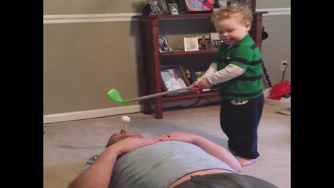 Kid fails to hit golf ball out dad's mouth