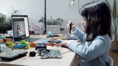 Girl Working with Computer Pieces