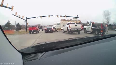 Watch this insane footage of a truck barreling through an intersection!