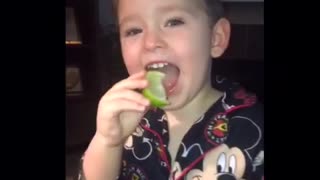 Little kid disney mickey mouse pajamas eats lime